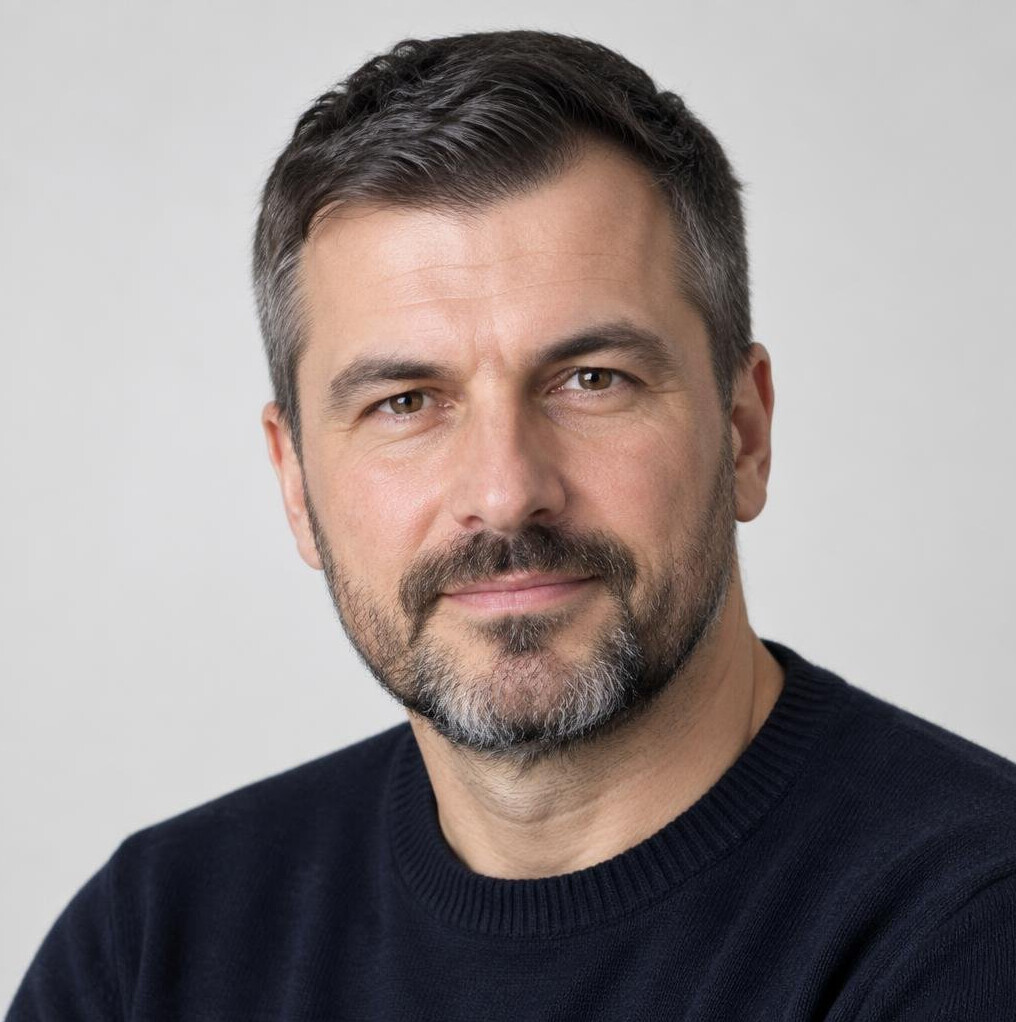 Studio portrait of a Croatian man with a beard wearing a sweater