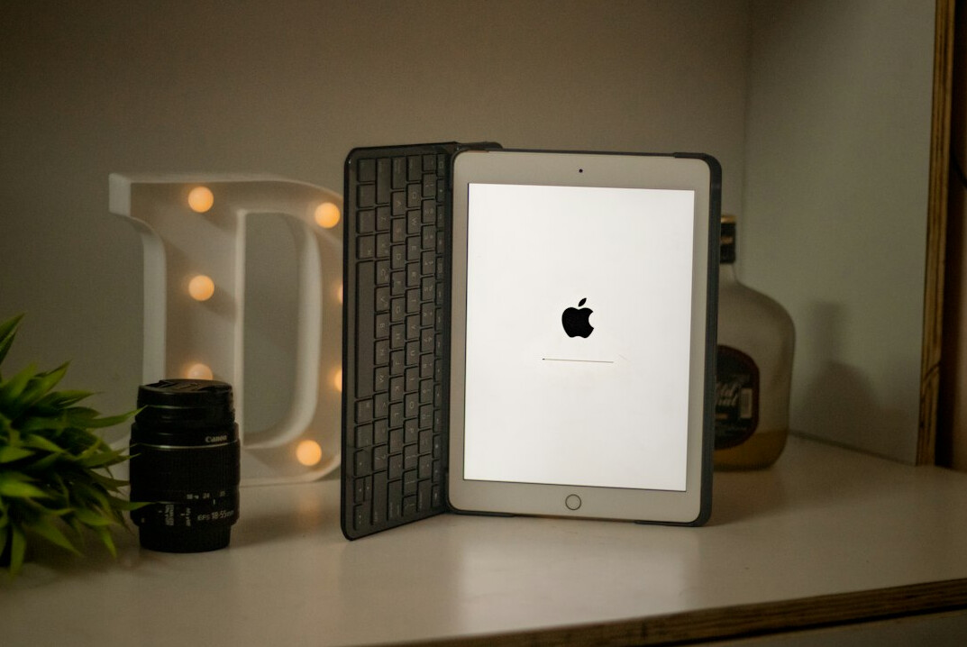 Tablet displaying digital documents and forms on an office desk